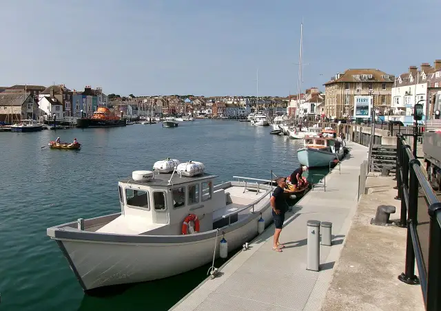 Fishing boats and colourful buildings around Weymouth Harbour